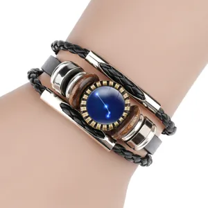 Close-up of retro leather bracelet featuring a blue zodiac constellation glass gem.