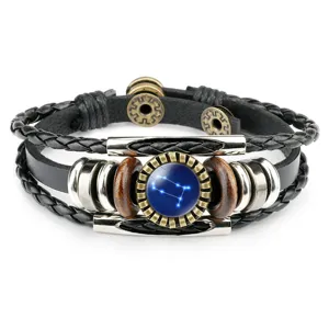 Detail of vintage leather bracelet featuring blue Gemini constellation glass gem cabochon.
