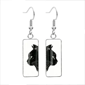Close-up of stylish rectangular glass earrings featuring a black cat illustration.