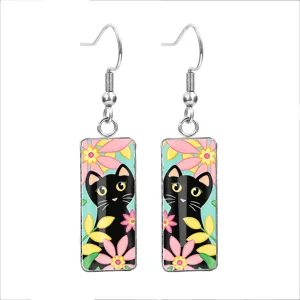 Macro view of cute black cat and colorful floral patterns on glass cabochon earrings hook