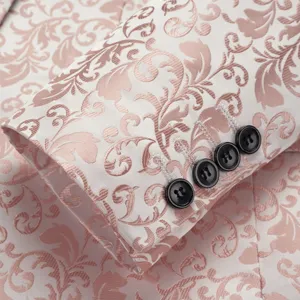 Detailed close-up of pink damask floral jacquard pattern on white men's slim fit suit sleeve