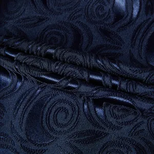 Detailed texture of navy blue floral jacquard fabric for men's slim fit suit
