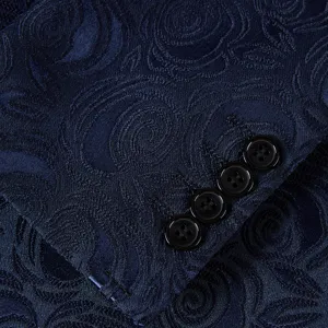 Detailed macro shot of navy blue floral jacquard suit sleeve featuring four black buttons