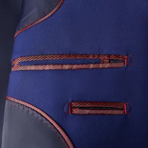 Detailed close-up of blue men's suit jacket interior pocket with red striped piping