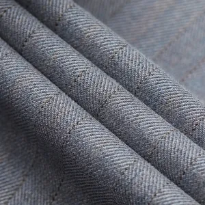 Macro texture view of light gray men's suit fabric featuring a premium twill weave design