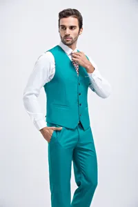 Professional male model posing in a teal formal vest suit with a crisp white shirt