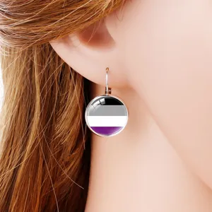 Macro detail of asexual pride flag time gem earring worn on a model's ear with long hair