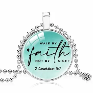 Detail view of a silver bead chain necklace with 'Walk by Faith' Bible verse glass pendant