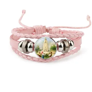 Detailed view of pink braided leather bracelet with Our Lady of Fatima glass cabochon