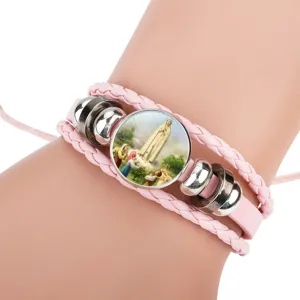 Detailed close-up of a pink multi-layer braided cowhide bracelet with religious Fatima icon
