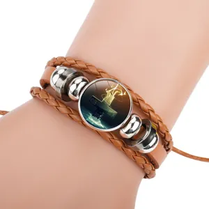 Detailed macro view of a multi-layer brown cowhide leather bracelet with a cross motif