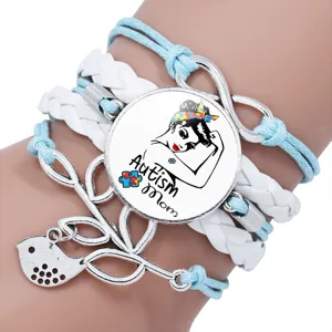 Close-up detail of a handmade multi-layer braided Autism Mom charm bracelet with puzzle pieces