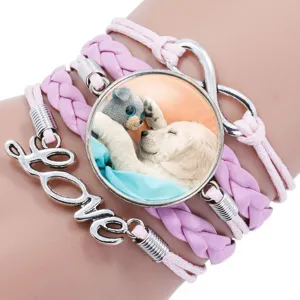 Close-up of multi-layer pink braided bracelet with Golden Retriever pup gem and Love charm