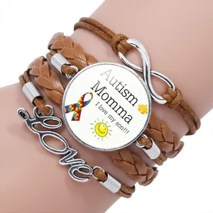 Detailed macro view of the Autism Momma multi-layer braided leather bracelet on a wrist