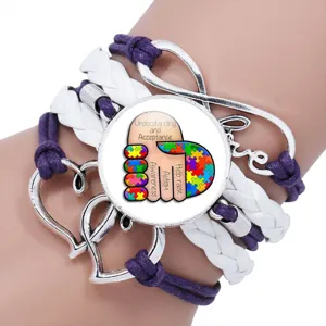Detailed view of handmade autism awareness bracelet with puzzle hand design and love charms