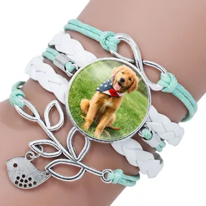 Close-up of multilayered braided bracelet with Golden Retriever puppy time gem charm