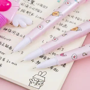 Cute pink angel wing click pens with cartoon patterns on a notebook layout