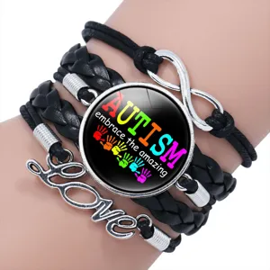 Close-up of autism awareness bracelet with Love charm and embrace the amazing message