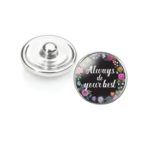 Détail d'un bouton pression en verre fleuri avec citation 'Always do your best'