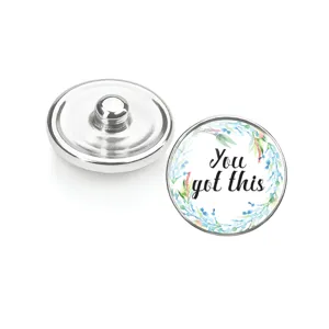 Gros plan sur des boutons-pression en verre à fleurs avec message You Got This