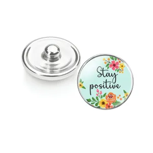 Vue détaillée des boutons-pression en verre fleuris avec citation motivante Stay positive