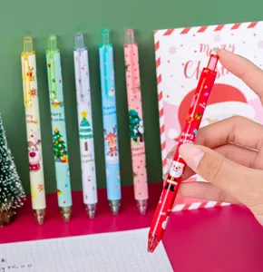 Macro detail of cartoon Santa Claus Christmas gel pen held in hand for student holiday gift