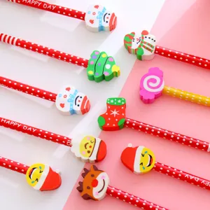 Close-up of assorted Christmas-themed pencils with decorative erasers and polka dots.