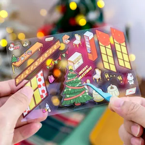 Primo piano di adesivi 3D per scene di case di Natale tenuti per decorazioni fai-da-te