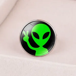 Detailed macro shot of an adjustable silver-tone ring featuring a green alien time gem design.