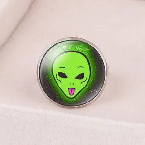 Close-up of green cartoon alien time gem adjustable ring with 'We Out Here' text