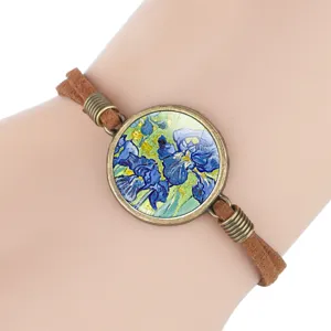 Close-up of Van Gogh Irises painting under glass cabochon on a brown suede bracelet.