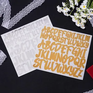 Close-up of 3-inch gold and silver alphabet stickers on a decorative background