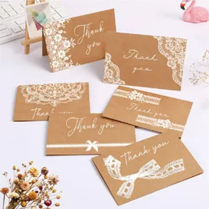 Detail of vintage kraft paper greeting cards with white lace and 'Thank you' text