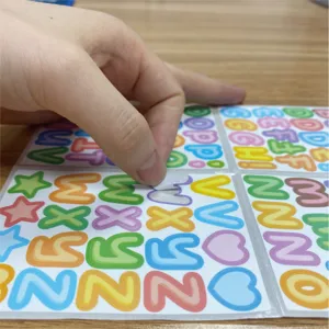 Detailed view of colorful cartoon alphabet stickers being peeled off