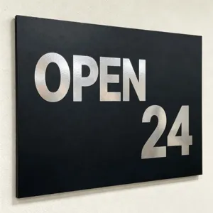 Close-up detail of waterproof metallic silver OPEN 24 alphabet and number stickers on board.