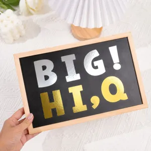 Detailed view of large 3-inch metallic gold and silver alphabet stickers on black surface