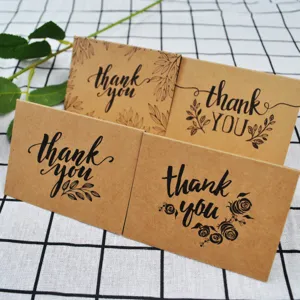 Close-up of four kraft paper thank you cards with vintage botanical designs