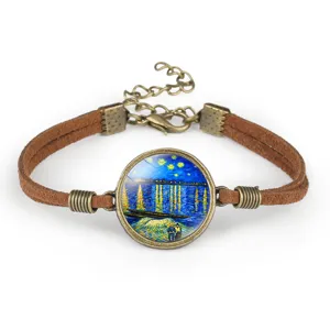 Close-up of Van Gogh's Starry Night glass cabochon on a brown suede rope bracelet