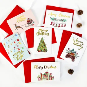 Detailed view of gold-stamped Christmas cards with red envelopes and festive motifs