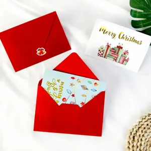 Detailed view of Christmas card set with gold stamping and red envelopes