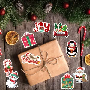 Detail showing festive cartoon Christmas stickers set on a gift box with pine branches