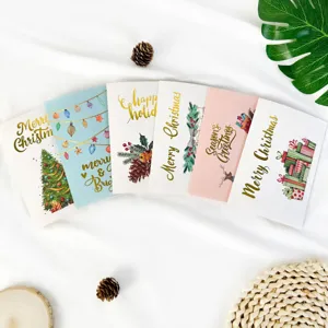 Assorted Christmas greeting cards with gold foil lettering and festive illustrations