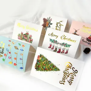Close-up of elegant gold foiled Christmas cards with various festive holiday designs