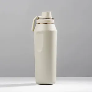 Botella de agua térmica grande de acero inoxidable crema con un asa de transporte portátil