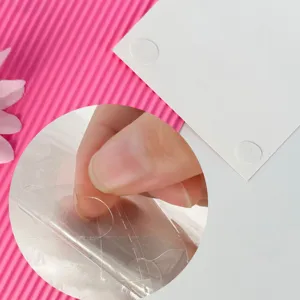 Detailed macro view showing clear circular adhesive glue dots for school name plates