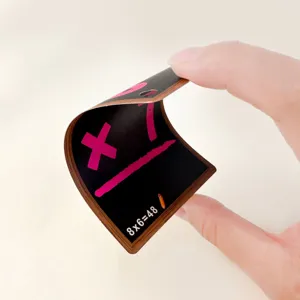 Close-up showing the flexibility of a black math flashcard for children's learning