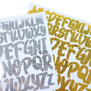 Macro detail of waterproof shiny gold and silver alphabet stickers with water droplets