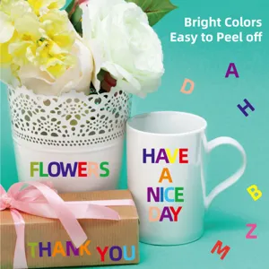Detail of colorful alphabet stickers on a mug, flower pot and gift box for DIY craft