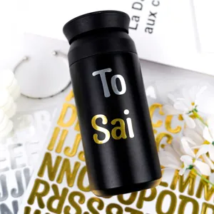 Detail view of 1-inch gold and silver alphabet stickers applied to a black bottle