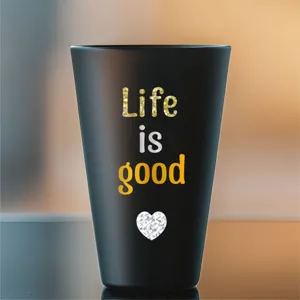Detailed macro view of waterproof 'Life is good' alphabet stickers applied on a black tumbler